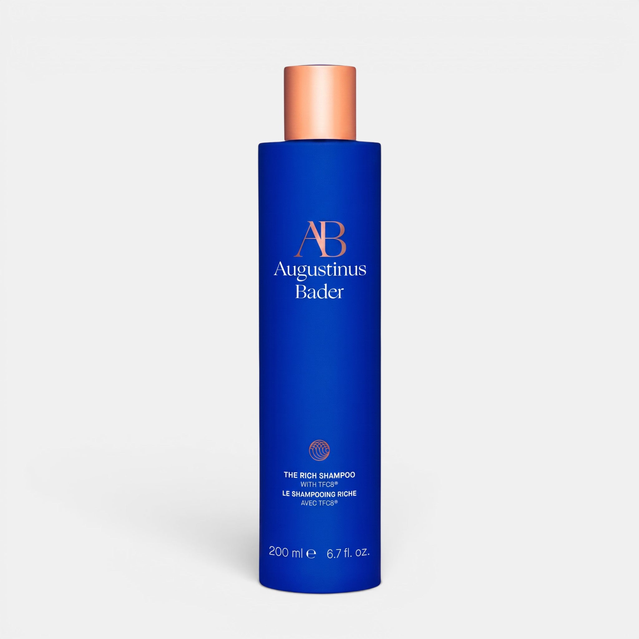 Shop Rescue Spa Augustinus Bader The Rich Shampoo in a blue bottle with a metallic cap for nourishing dry hair.