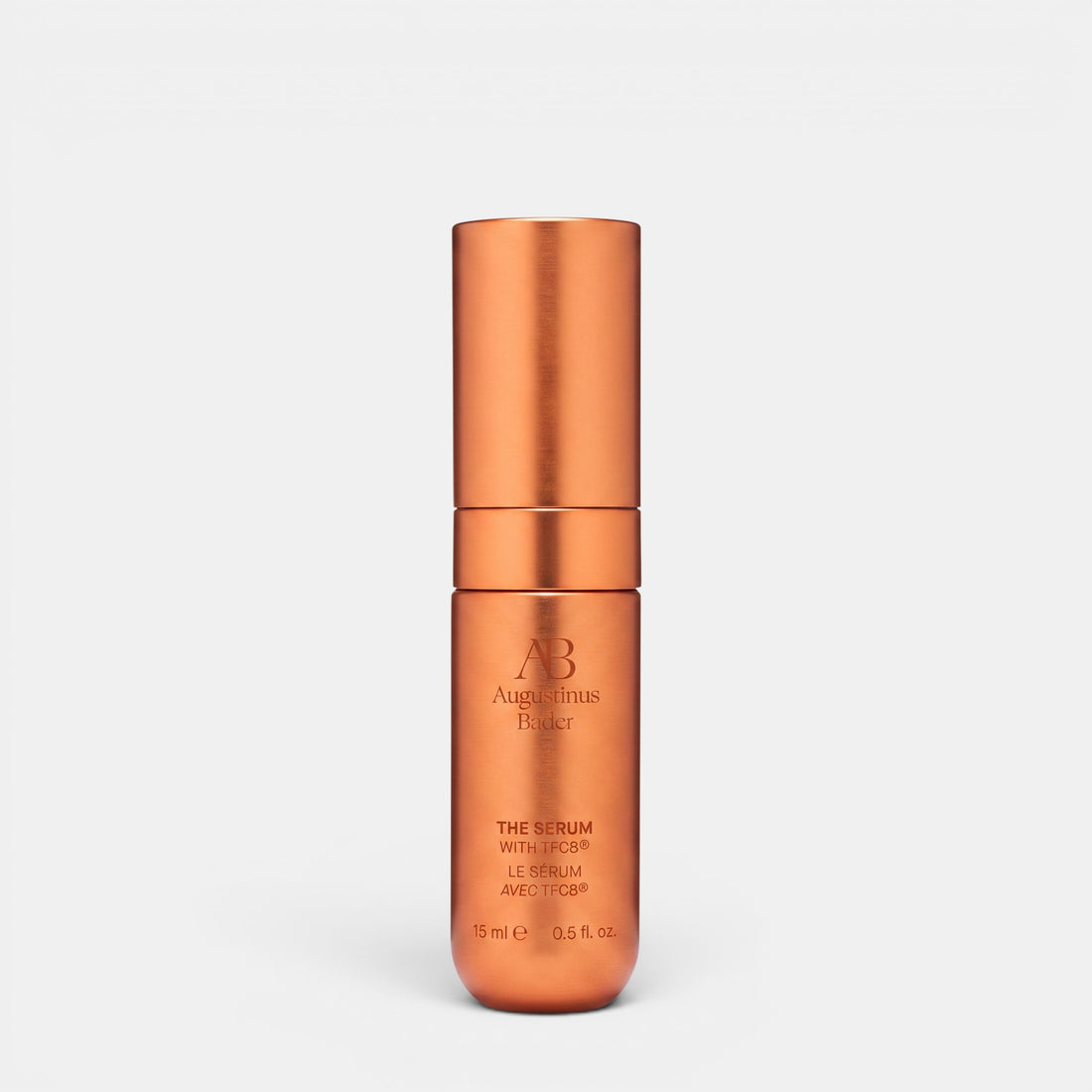 Shop Rescue Spa Augustinus Bader The Serum Nomad 15ml in a metallic copper cylindrical bottle for skin rejuvenation.