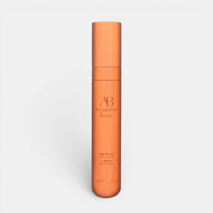 Shop Rescue Spa Augustinus Bader The Serum Nomad 30ml in a sleek metallic copper cylindrical bottle.