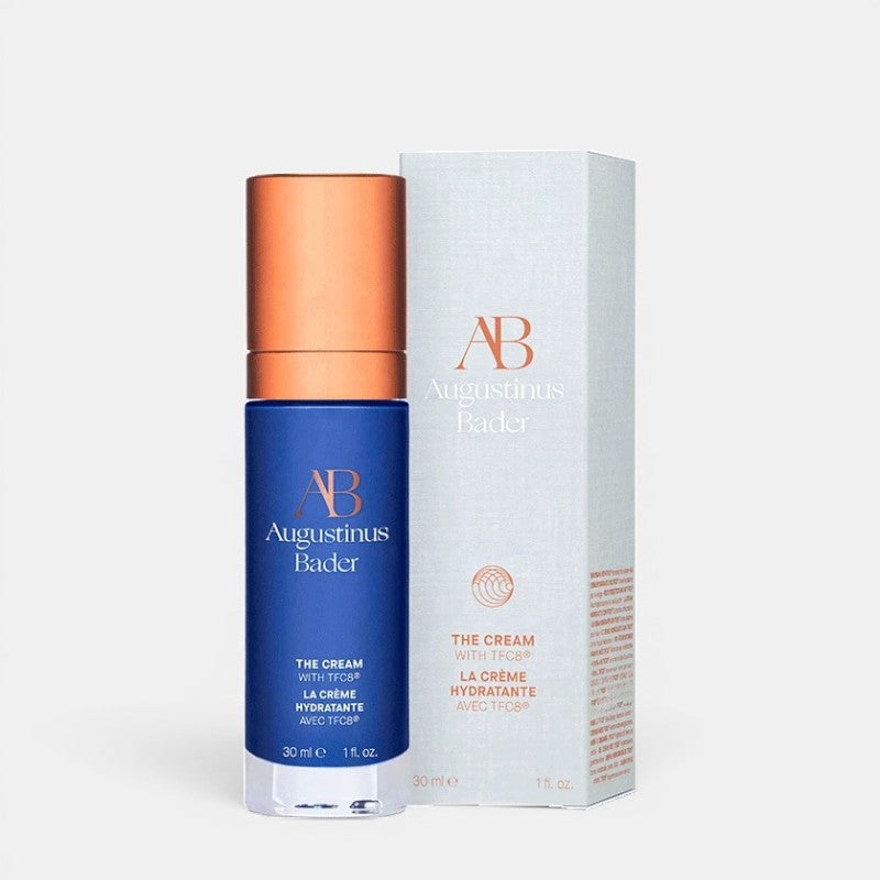 Shop Rescue Spa Augustinus Bader The Cream moisturizer in a blue bottle with copper cap and matching product box.