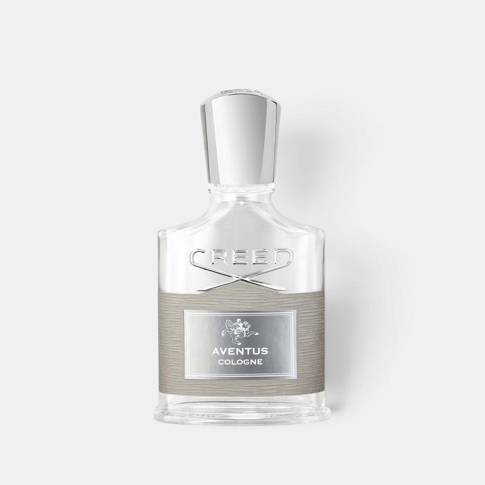 Shop Rescue Spa Aventus Cologne fragrance bottle with a clear glass design, silver cap, and grey textured label.