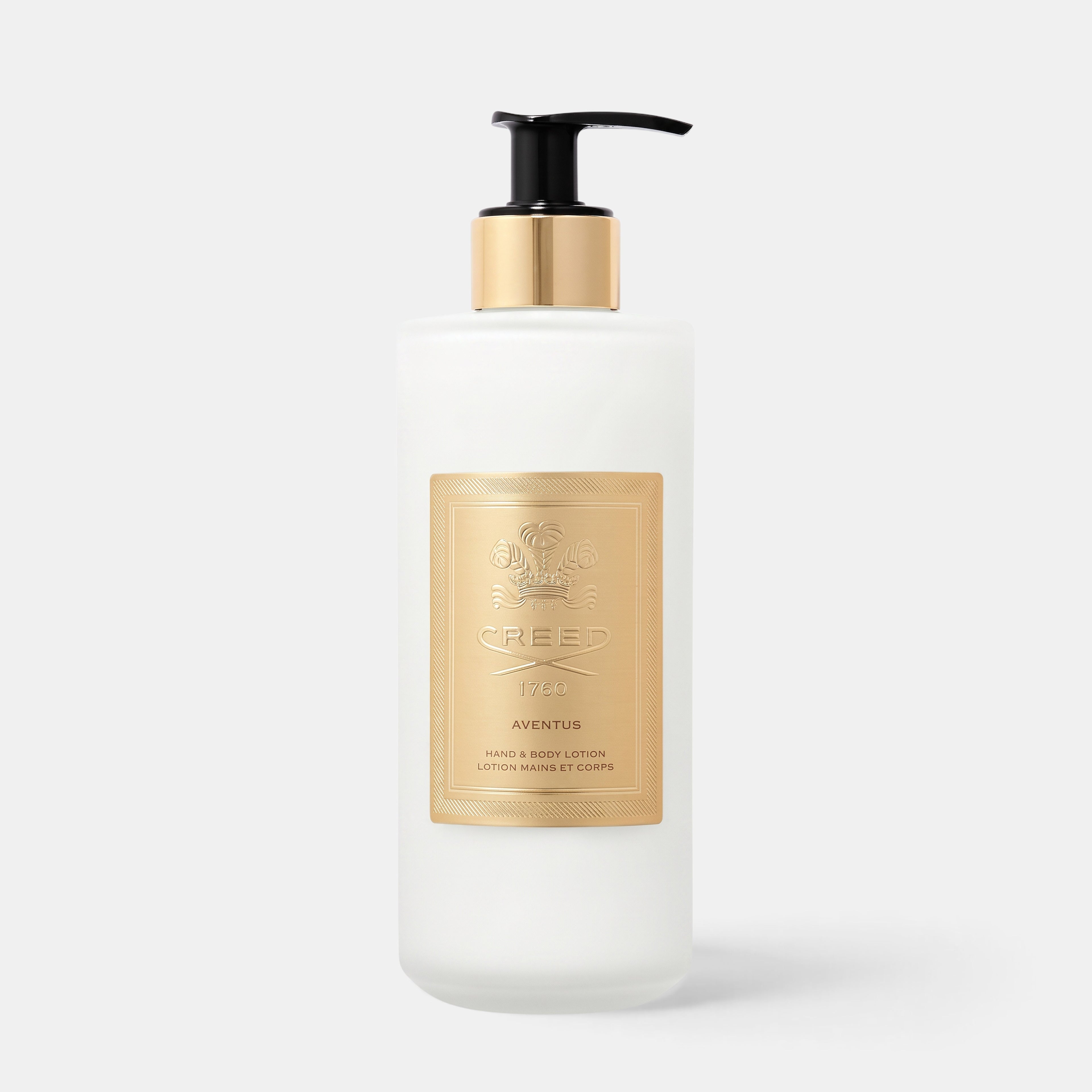 Shop Rescue Spa Aventus Hand &amp; Body Lotion in a frosted glass bottle with a gold label and black pump dispenser.