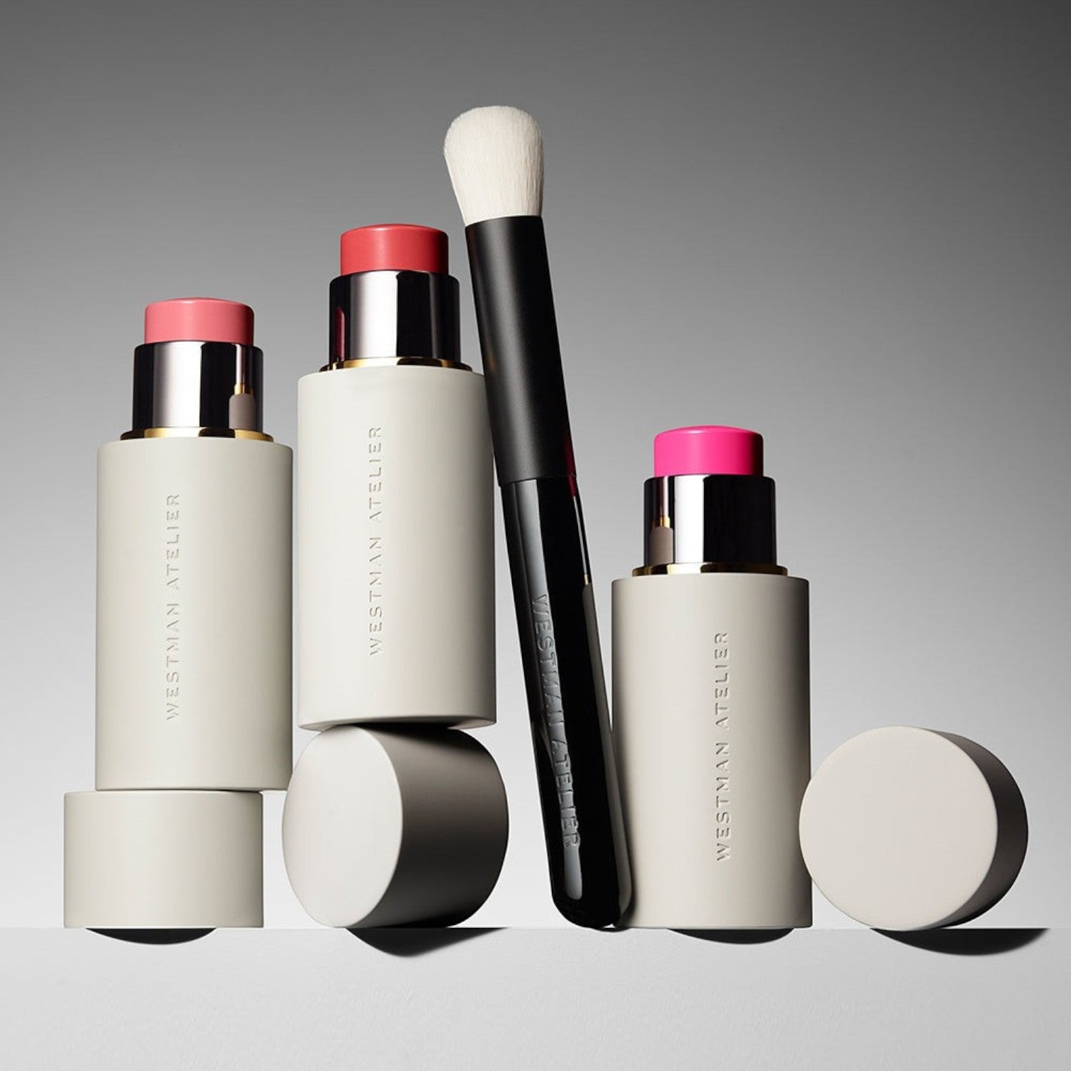 Shop Rescue Spa Baby Blender Brush with soft nylon bristles next to Westman Atelier cream blush sticks