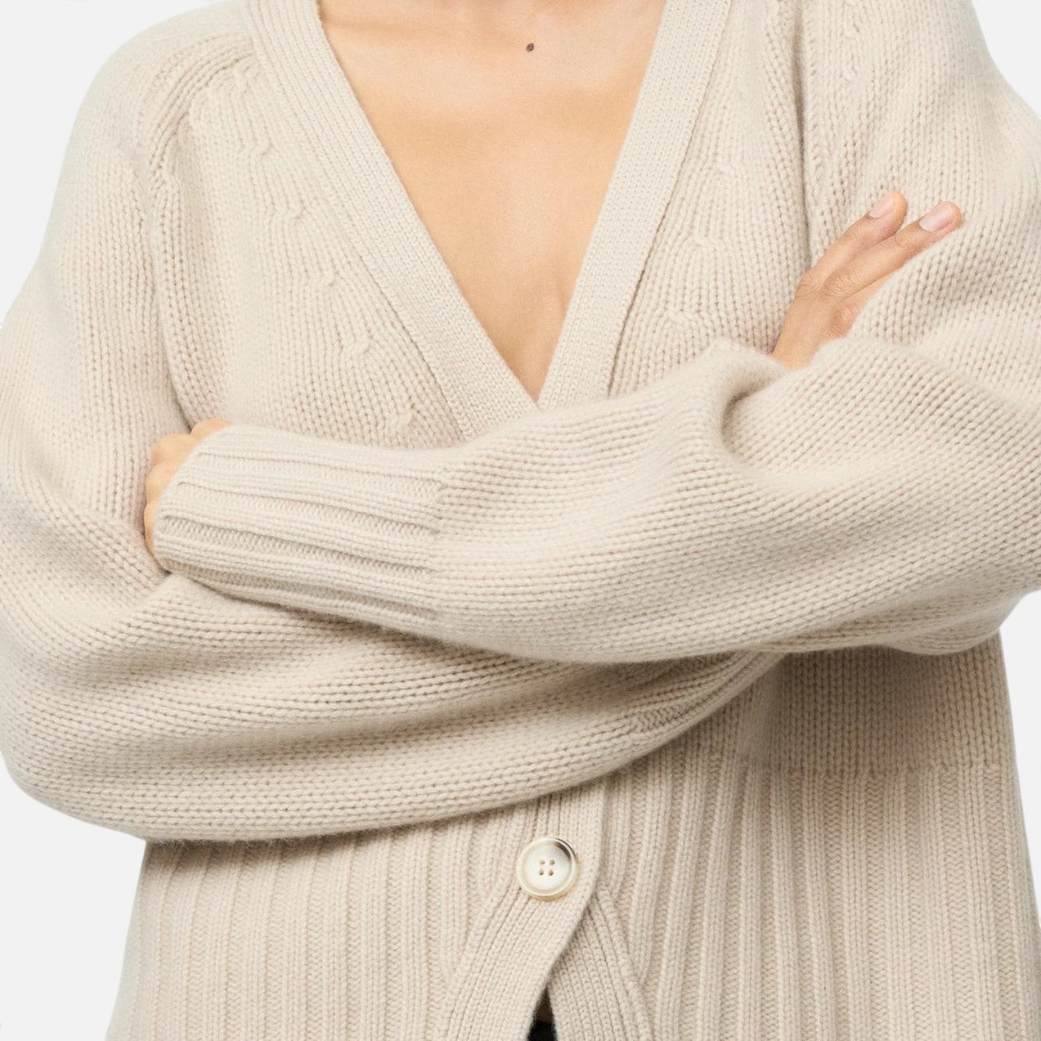 Shop Rescue Spa beige chunky knit cashmere V-neck cardigan with button detail on a model