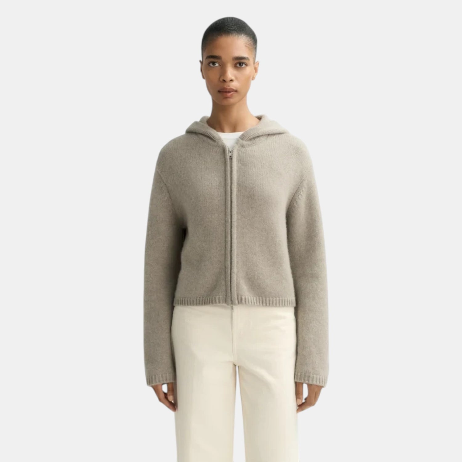 Shop Rescue Spa chunky knit cashmere hoodie in beige with a front zipper worn by a model