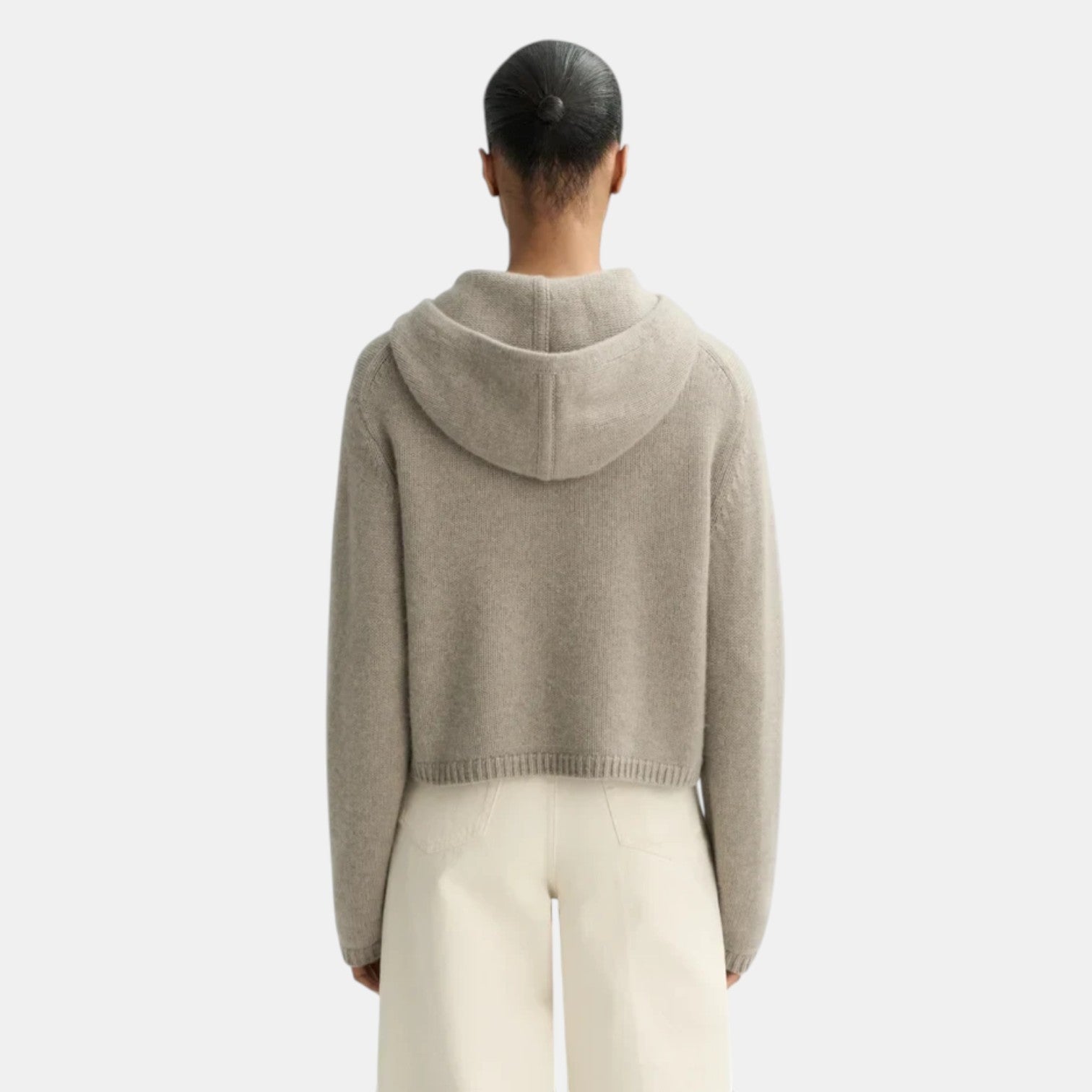Back view of a Shop Rescue Spa chunky knit cashmere hoodie in beige, featuring a hood and ribbed hem.