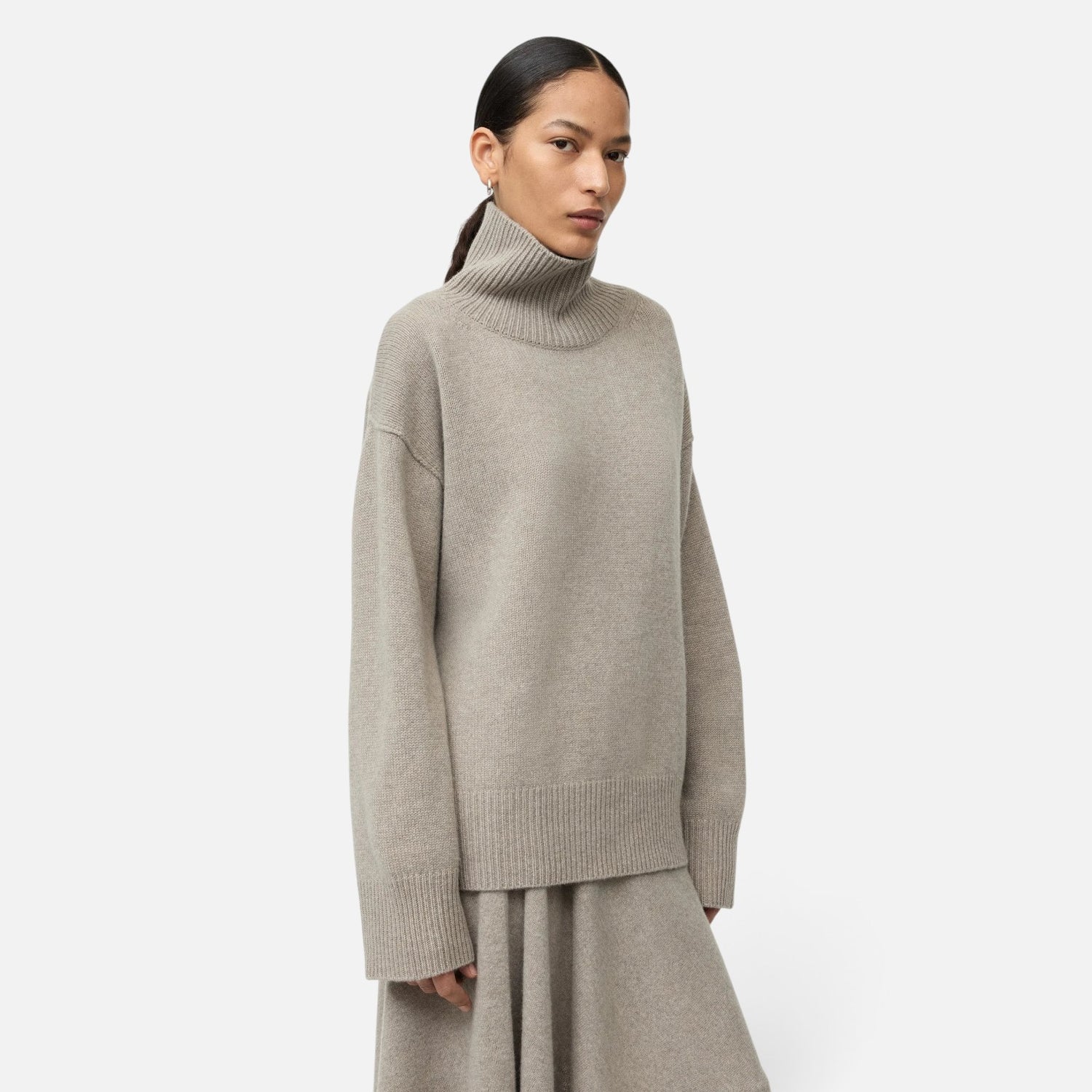 Shop Rescue Spa oversized beige cashmere turtleneck sweater with a chunky knit texture worn by a model