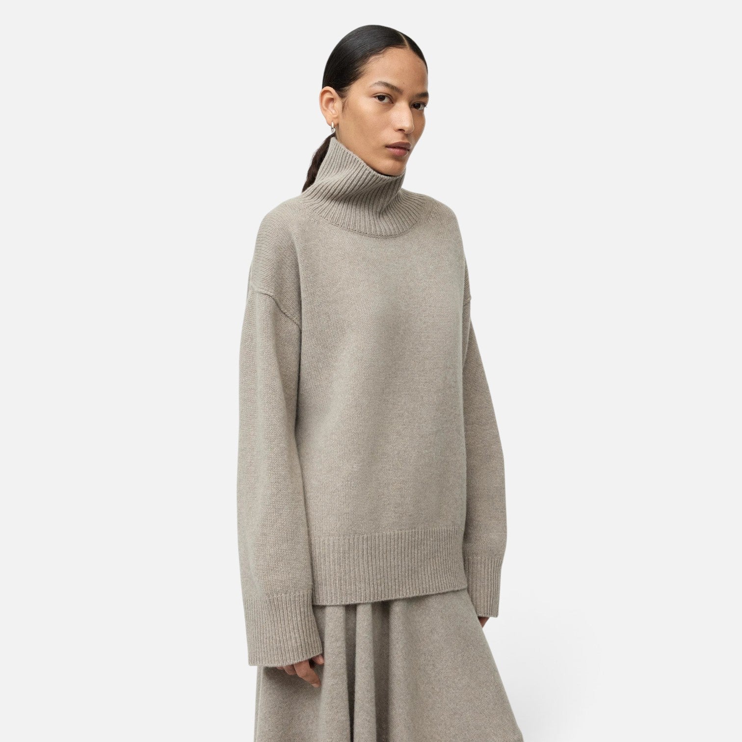 Shop Rescue Spa oversized beige cashmere turtleneck sweater with a chunky knit texture worn by a model
