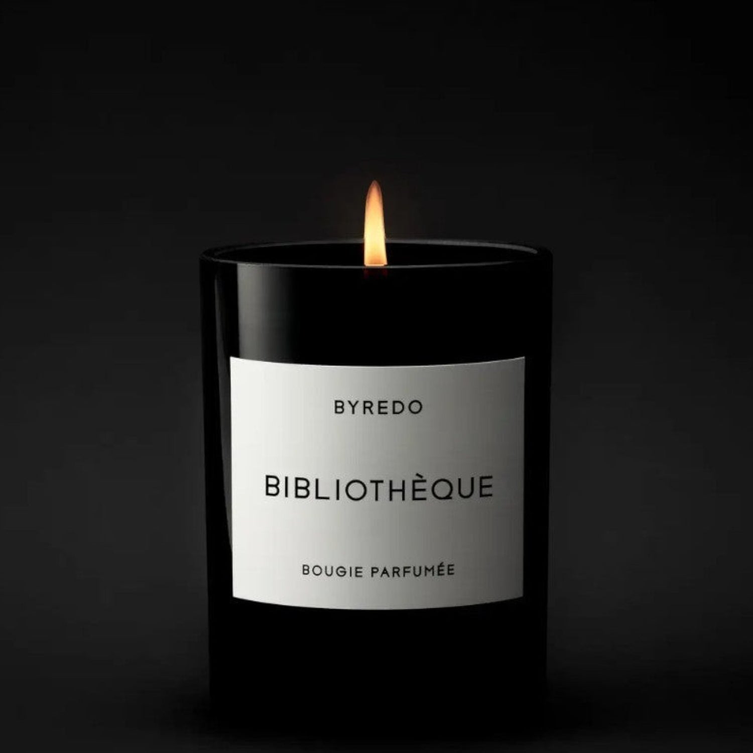 Shop Rescue Spa Bibliotheque candle in a black glass jar with a white label, featuring notes of peach, plum, peony, violet, leather, patchouli, and vanilla.