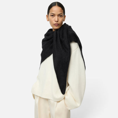 Shop Rescue Spa black brushed cashmere scarf draped over a model wearing a cream knit sweater