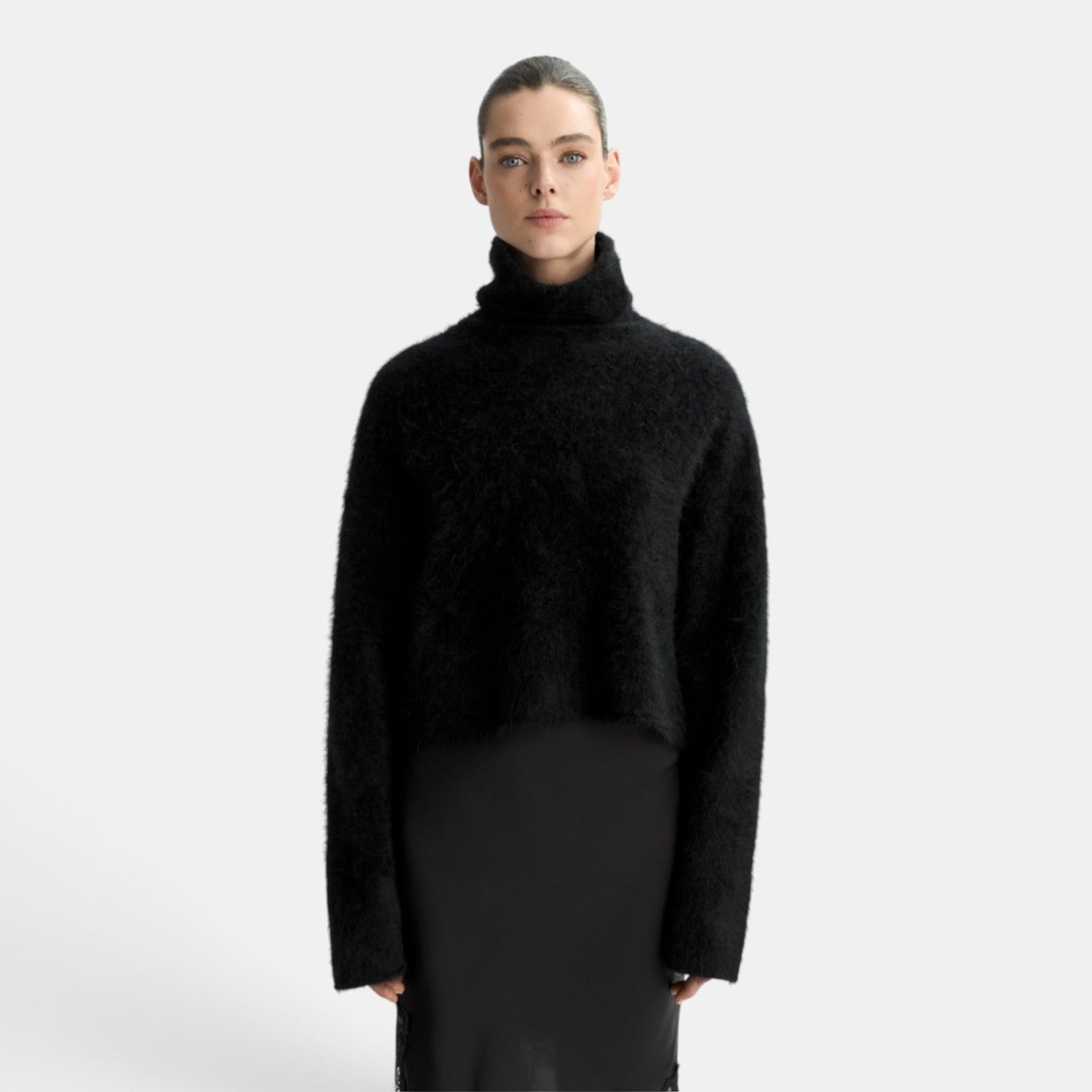 Shop Rescue Spa black brushed cashmere turtleneck sweater worn by a model in a regular fit.