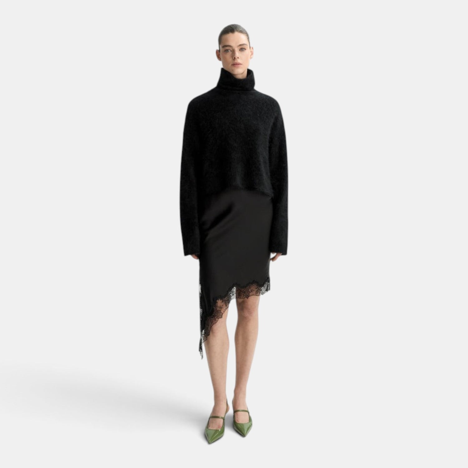 Shop Rescue Spa black brushed cashmere turtleneck sweater worn with a black lace-trimmed asymmetrical skirt