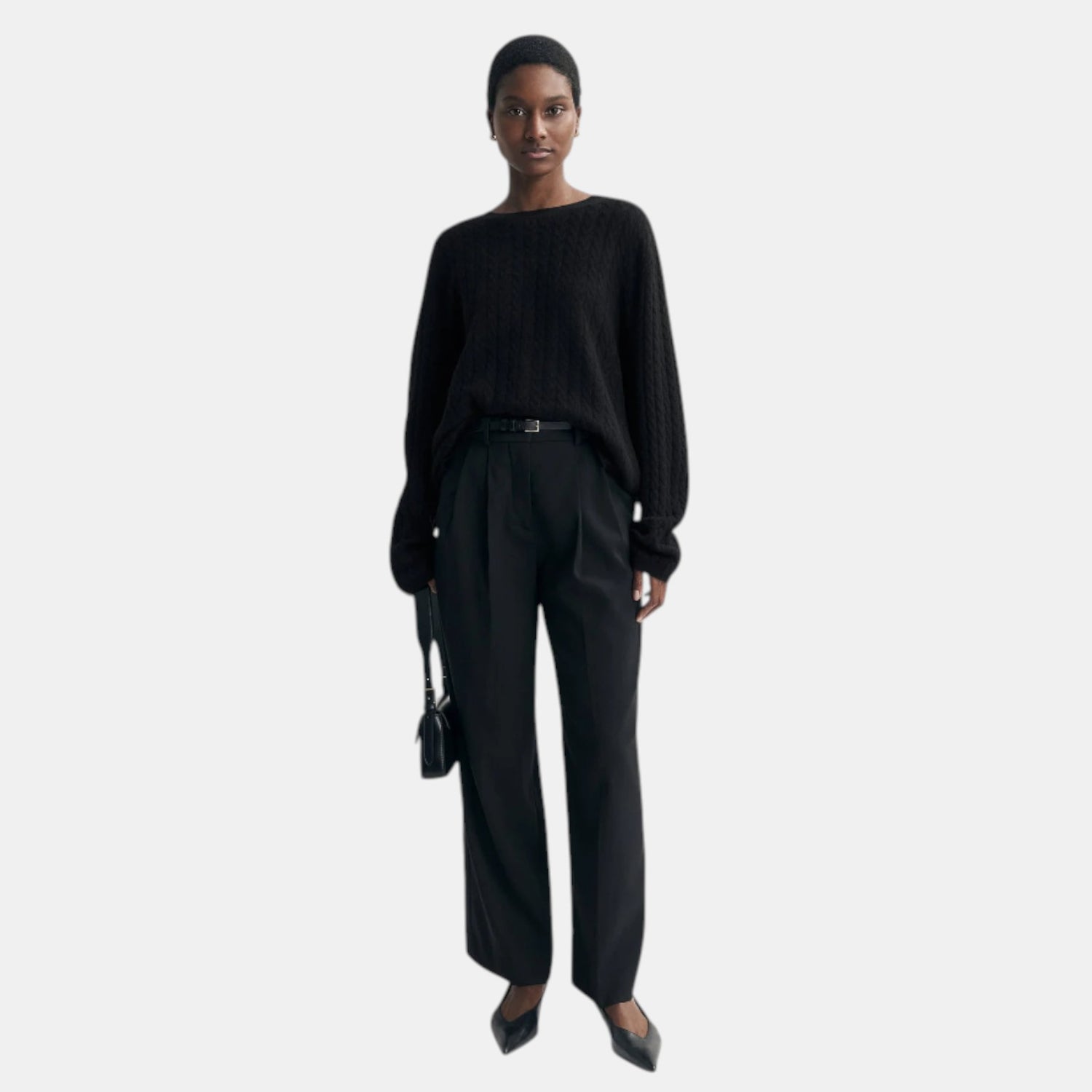 Shop Rescue Spa black oversized cable knit cashmere sweater worn by a model with black trousers and heels