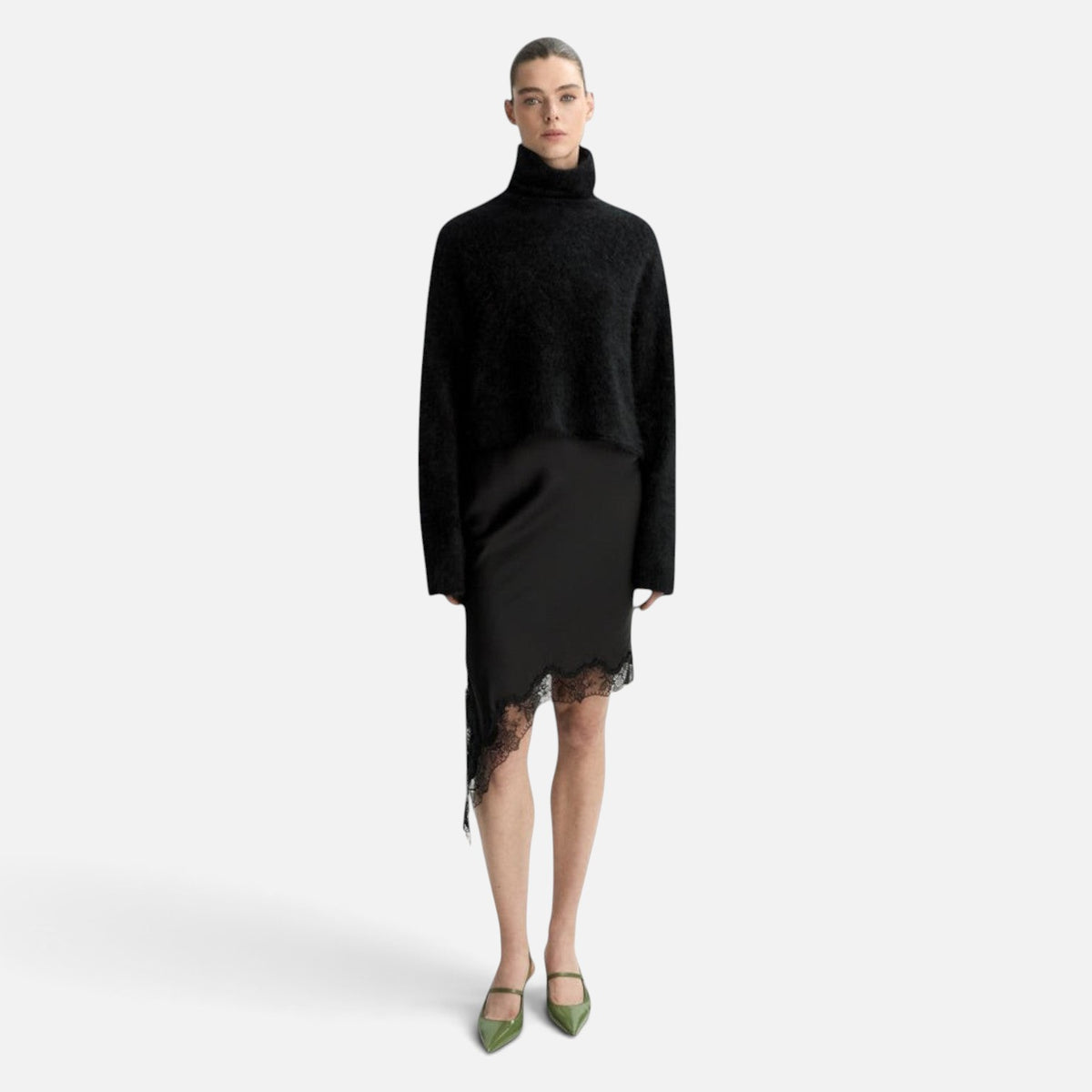 Shop Rescue Spa black chunky cashmere turtleneck sweater with sleeve slits worn with a black lace-trimmed skirt