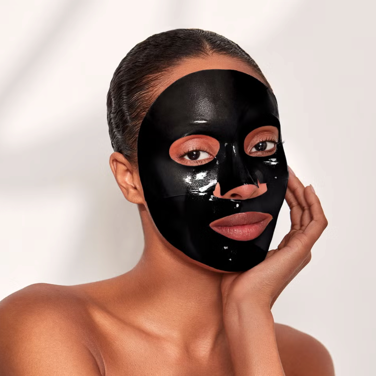 Shop Rescue Spa Celestial Black Diamond lifting and firming sheet mask on a woman&