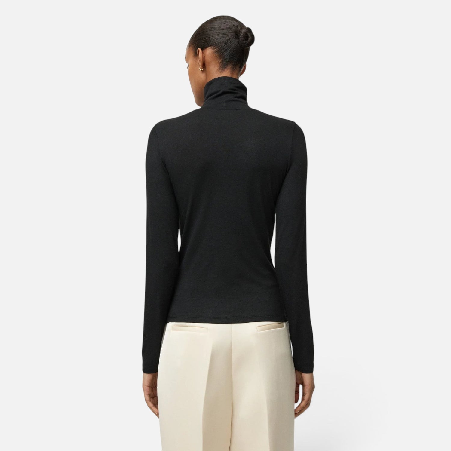 Shop Rescue Spa black lightweight jersey turtleneck worn by a model, back view showing long sleeves and slim fit.