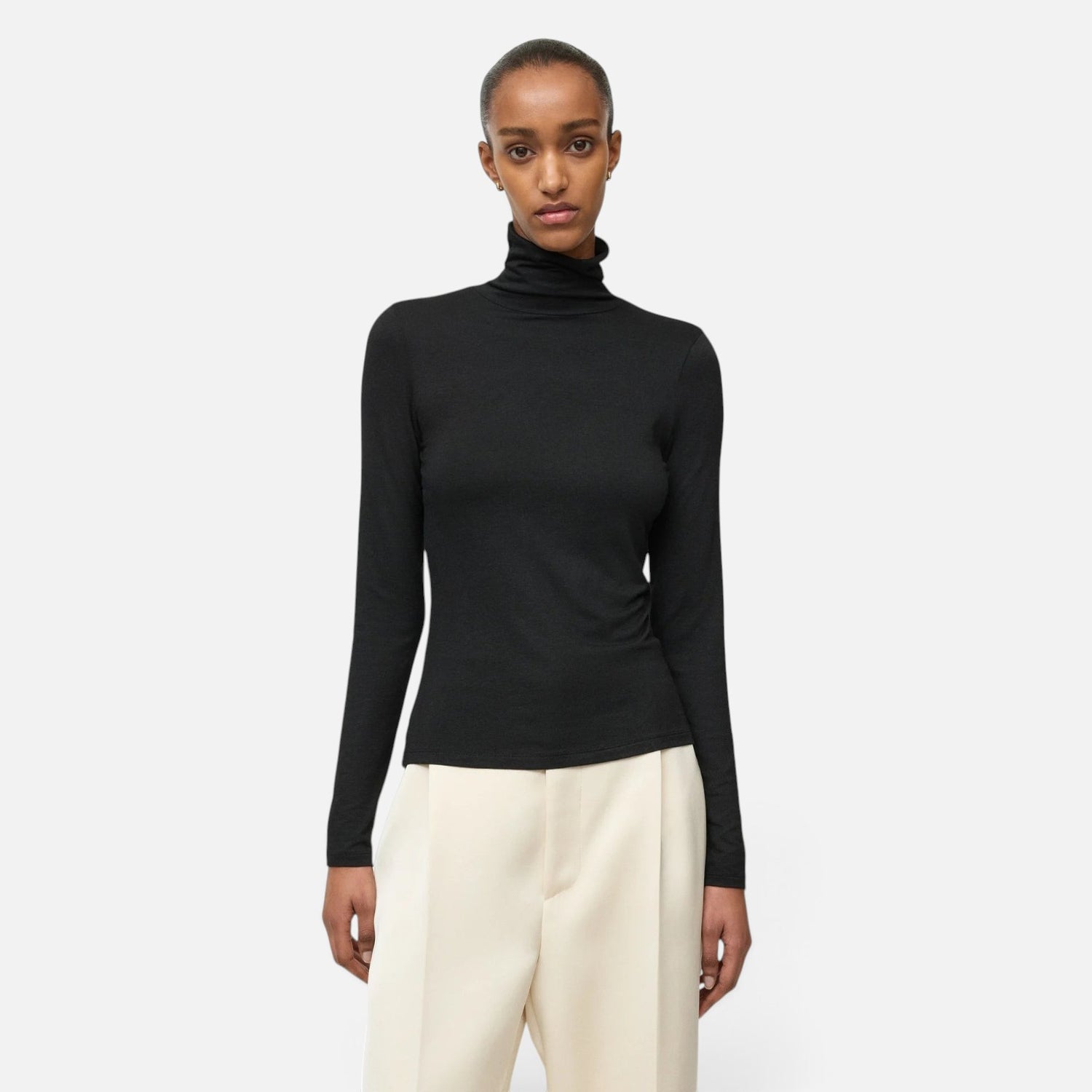 Shop Rescue Spa lightweight black jersey turtleneck made from a Tencel and cashmere blend worn by a model