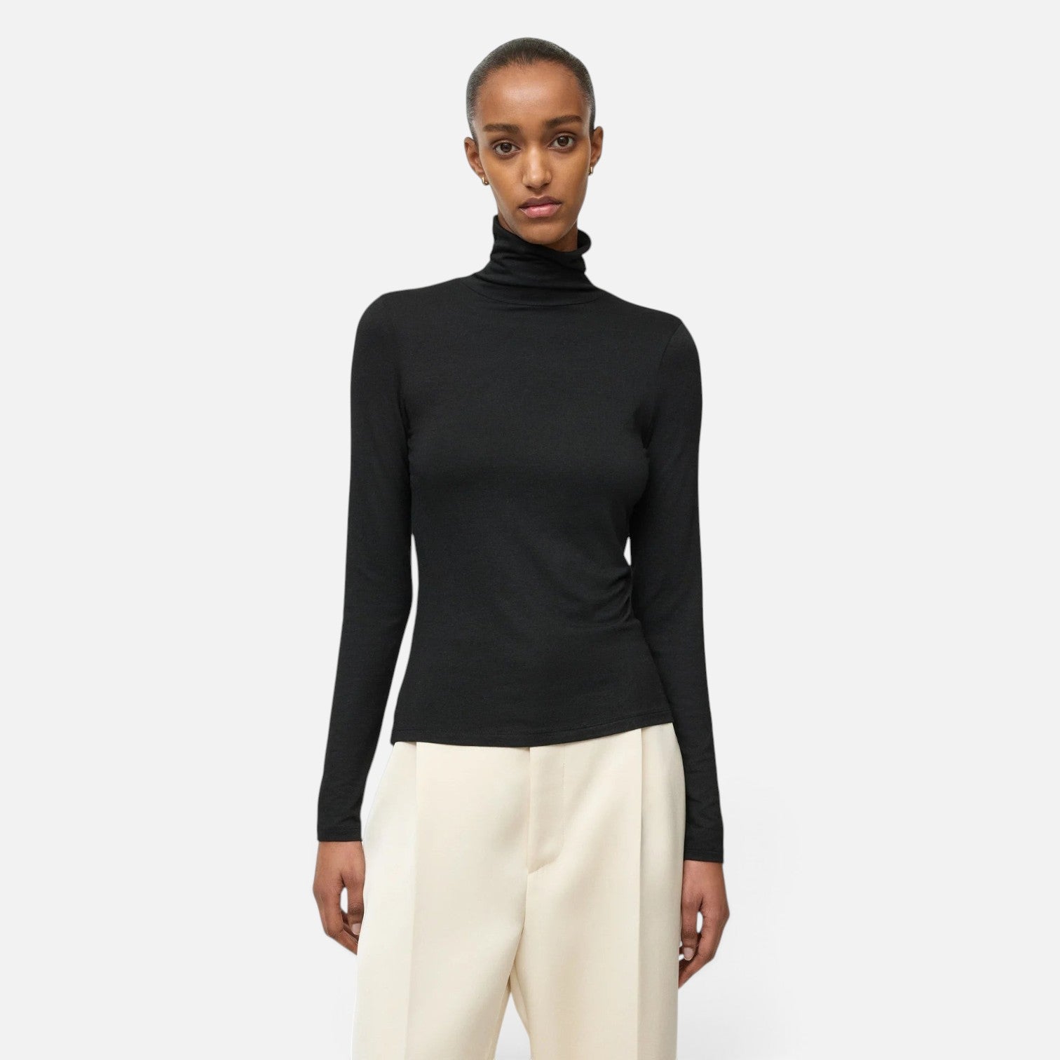 Shop Rescue Spa lightweight black jersey turtleneck made from a Tencel and cashmere blend worn by a model