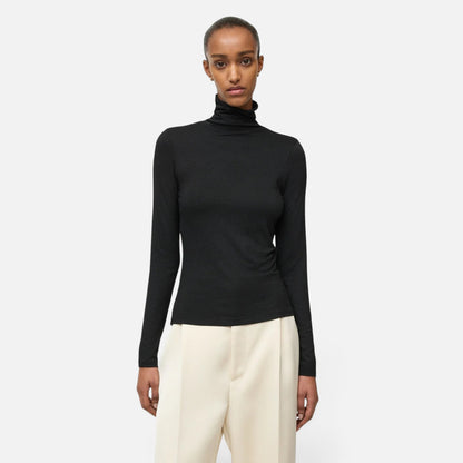 Shop Rescue Spa lightweight black jersey turtleneck made from a Tencel and cashmere blend worn by a model