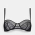 Shop Rescue Spa Facettes black demi-cup bra featuring delicate floral lace patchwork and graphic trim.