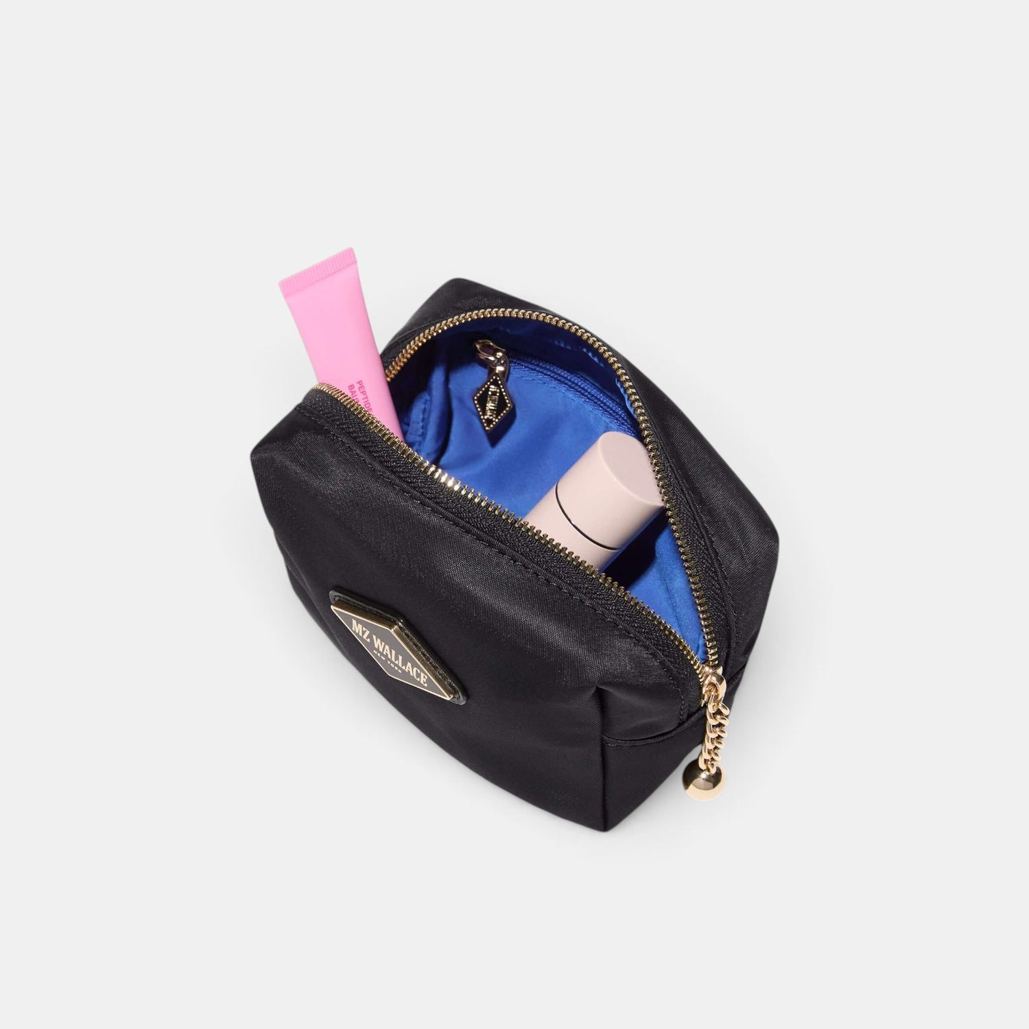 Shop Rescue Spa black nylon Ava cosmetic bag with blue interior lining, leather trim, and matte black hardware.