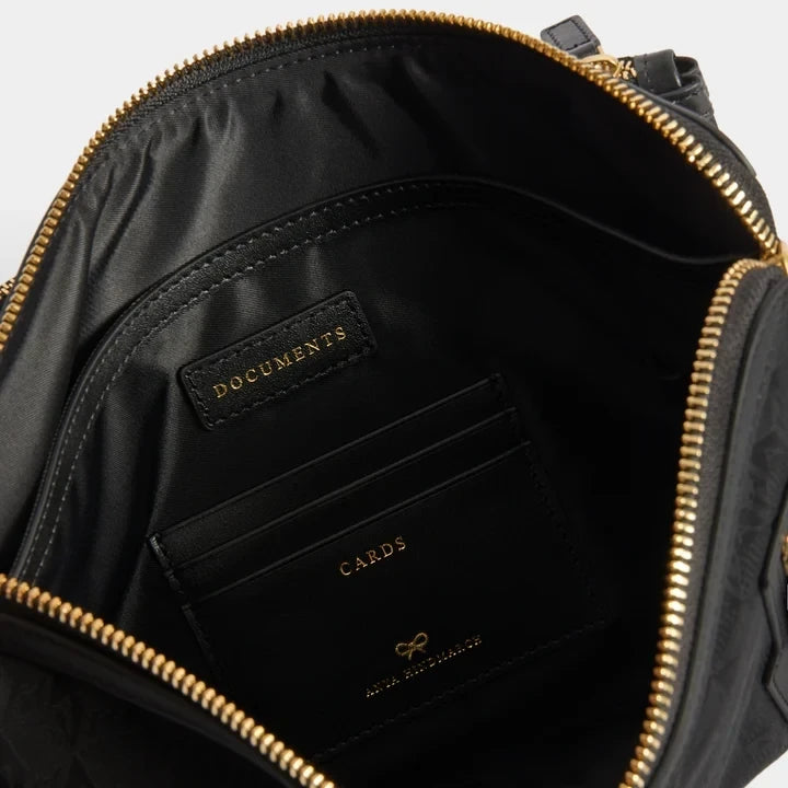 Shop Rescue Spa black nylon Journey Essentials pochette interior with gold zip, document pocket, and card slots.