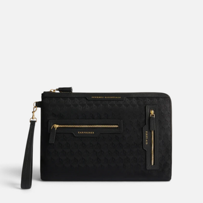Shop Rescue Spa black nylon Journey Essentials travel pouch with gold zippers and labelled external pockets.