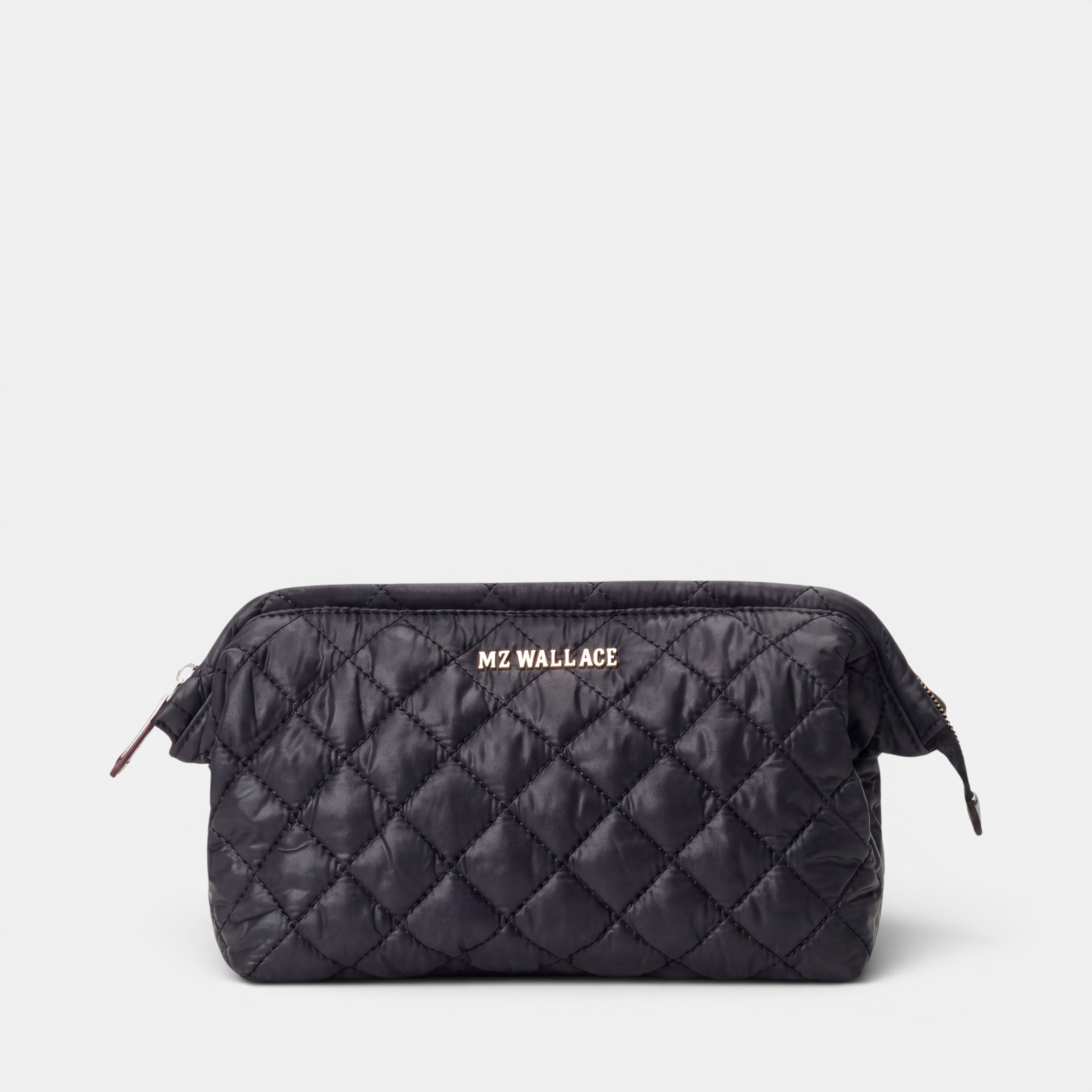 Shop Rescue Spa Crosby Frame cosmetic bag in black quilted REC Oxford fabric with silver hardware and leather trim.