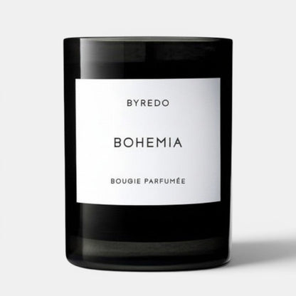 Shop Rescue Spa Bohemia scented candle in a black glass jar with a white label. Woody scent with notes of opoponax, rum, vanilla, sandalwood, and oak moss.