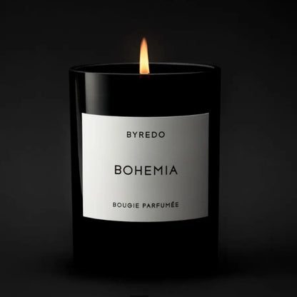 Shop Rescue Spa Bohemia scented candle in a black glass jar with a white label, burning with a warm flame.