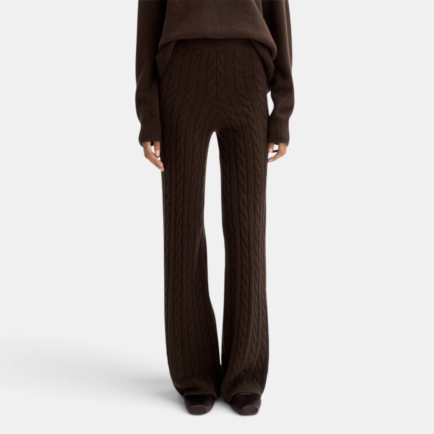 Shop Rescue Spa dark brown cable knit cashmere pants with an elastic waist, shown in a regular fit on a model.