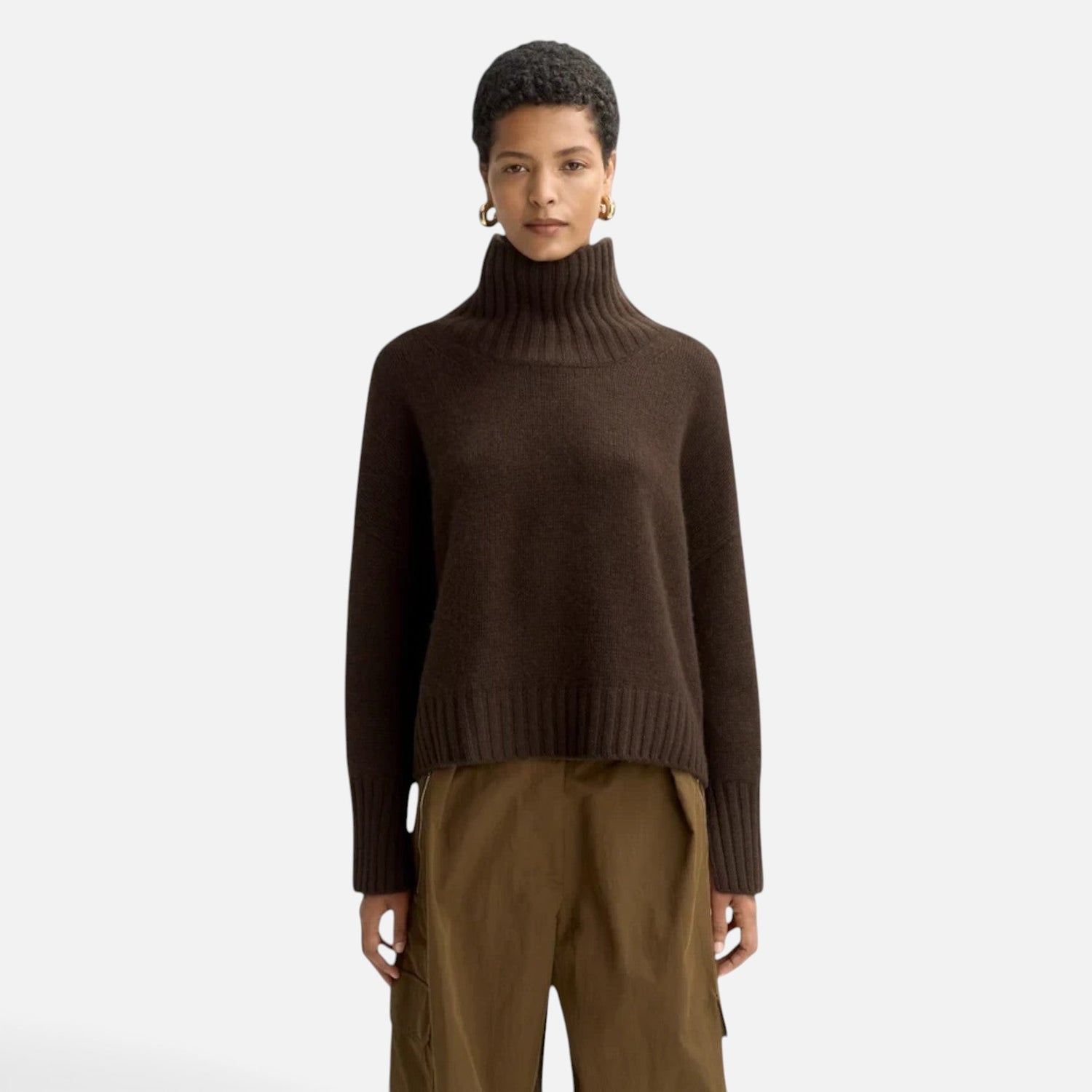 Model wearing a Shop Rescue Spa chunky dark brown cashmere turtleneck sweater with sleeve slits