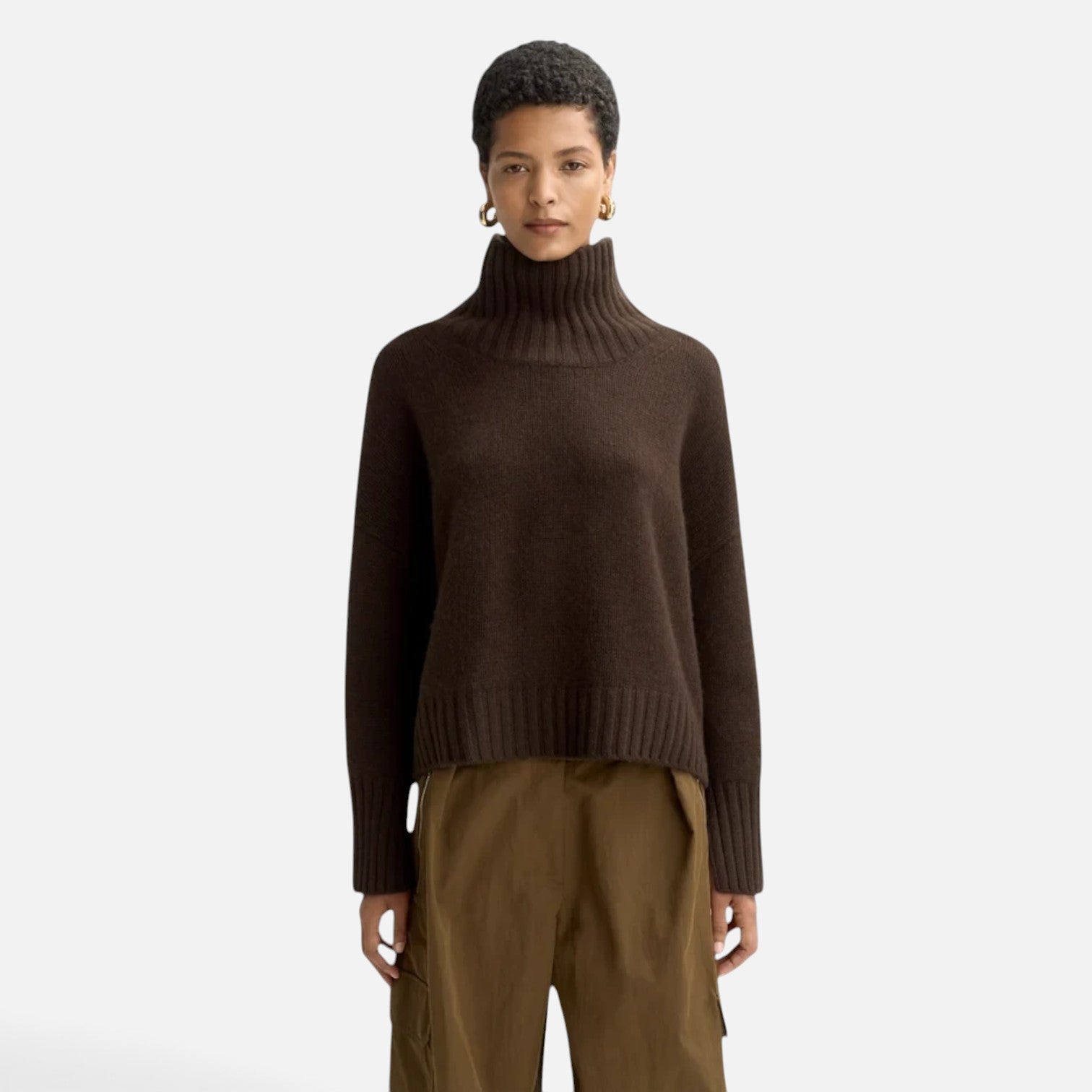 Model wearing a Shop Rescue Spa chunky dark brown cashmere turtleneck sweater with sleeve slits