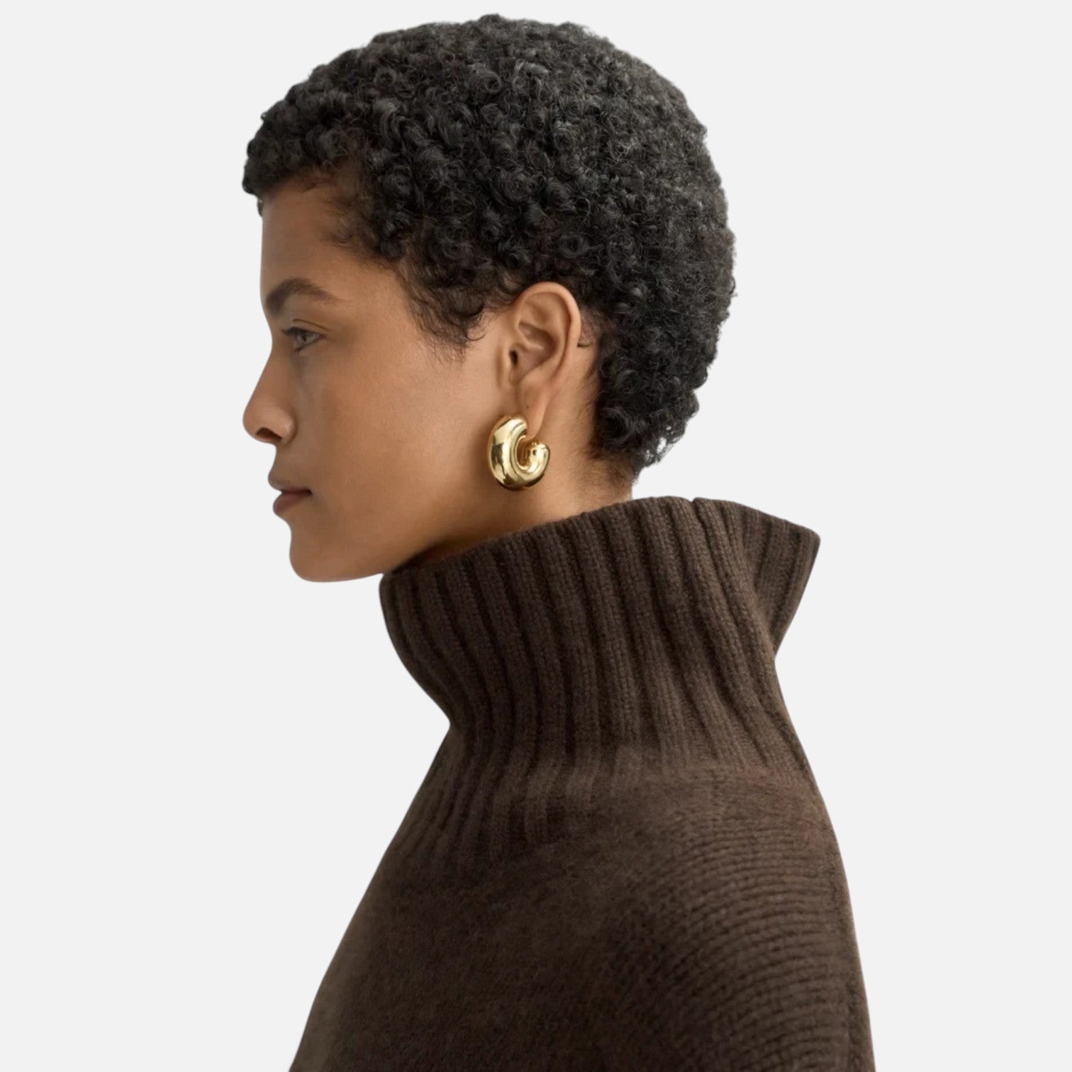 Shop Rescue Spa Girlfriend turtleneck in dark brown chunky cashmere knit worn by a model in profile view