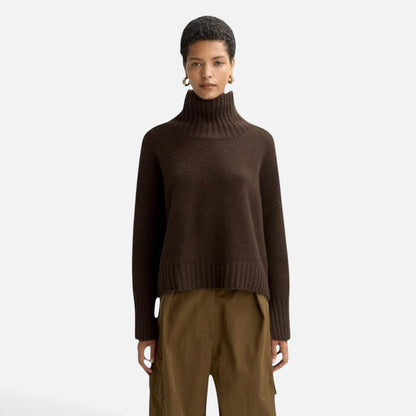 Shop Rescue Spa Girlfriend turtleneck sweater in dark brown chunky cashmere with sleeve slits on a female model