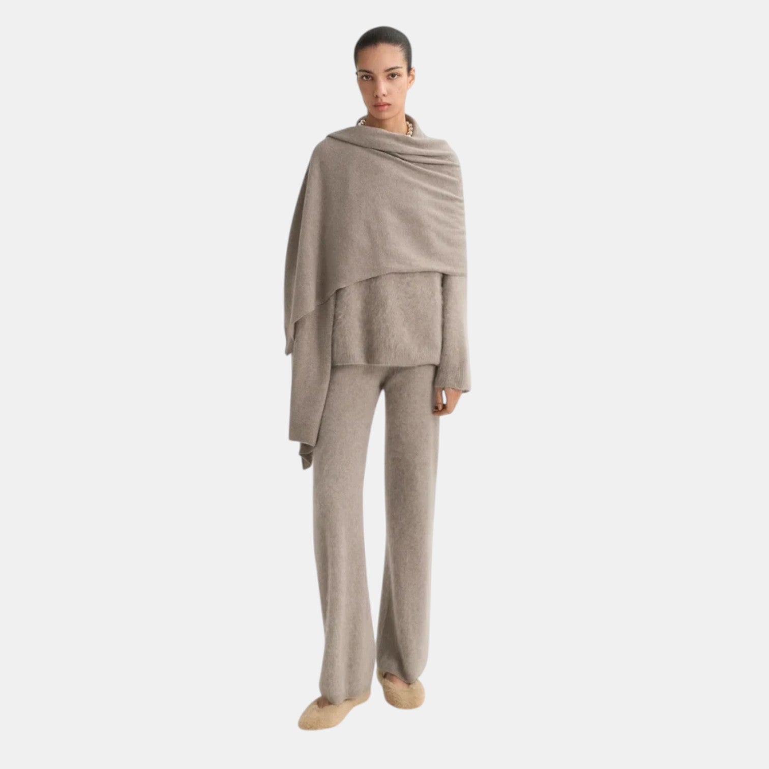 Model wearing Shop Rescue Spa brushed cashmere knit pants in beige with a matching sweater and draped scarf