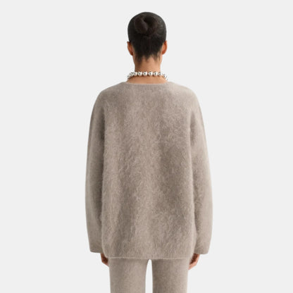 Back view of Shop Rescue Spa brushed cashmere v-neck sweater in beige, featuring a soft knit texture.