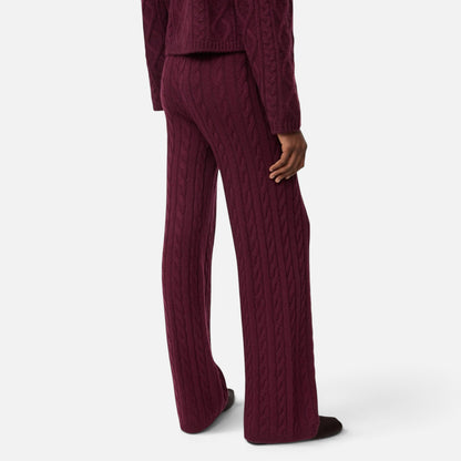 Shop Rescue Spa burgundy cable knit cashmere pants with an elastic waist, shown from a rear view on a model.