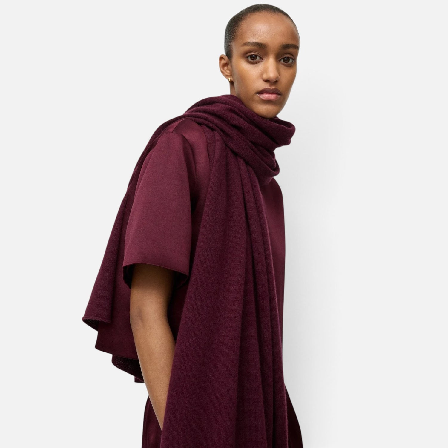 Shop Rescue Spa fine knit burgundy cashmere scarf worn by a model in a studio setting