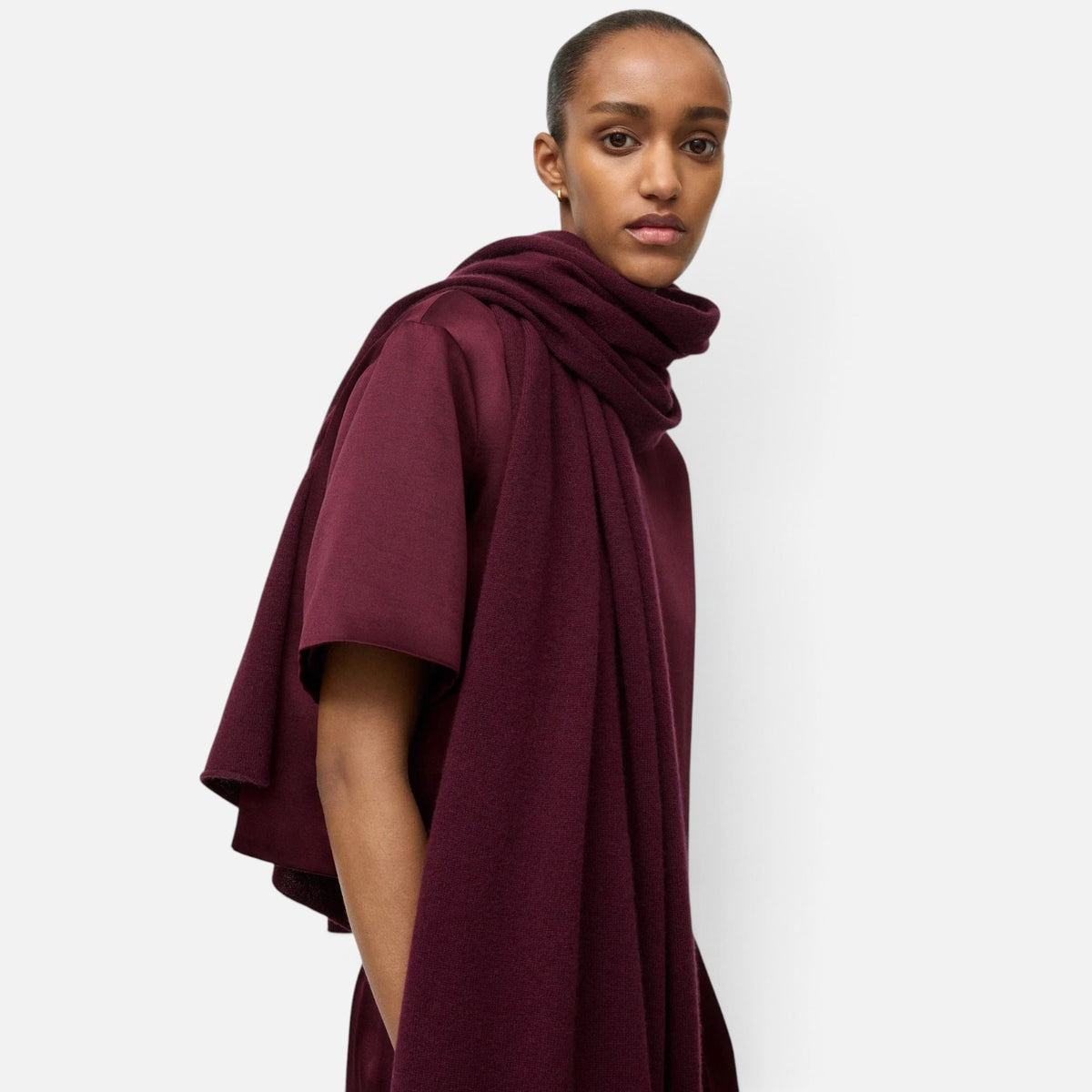 Shop Rescue Spa fine knit burgundy cashmere scarf worn by a model in a studio setting