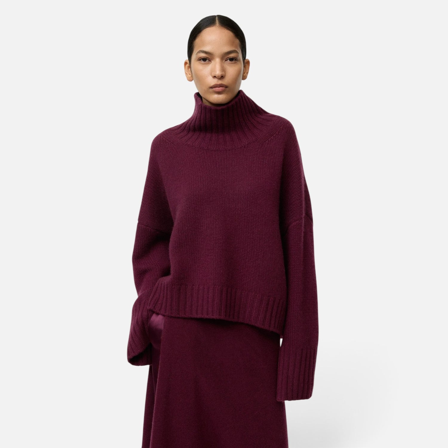 Shop Rescue Spa burgundy chunky cashmere turtleneck sweater with sleeve slits worn by a model
