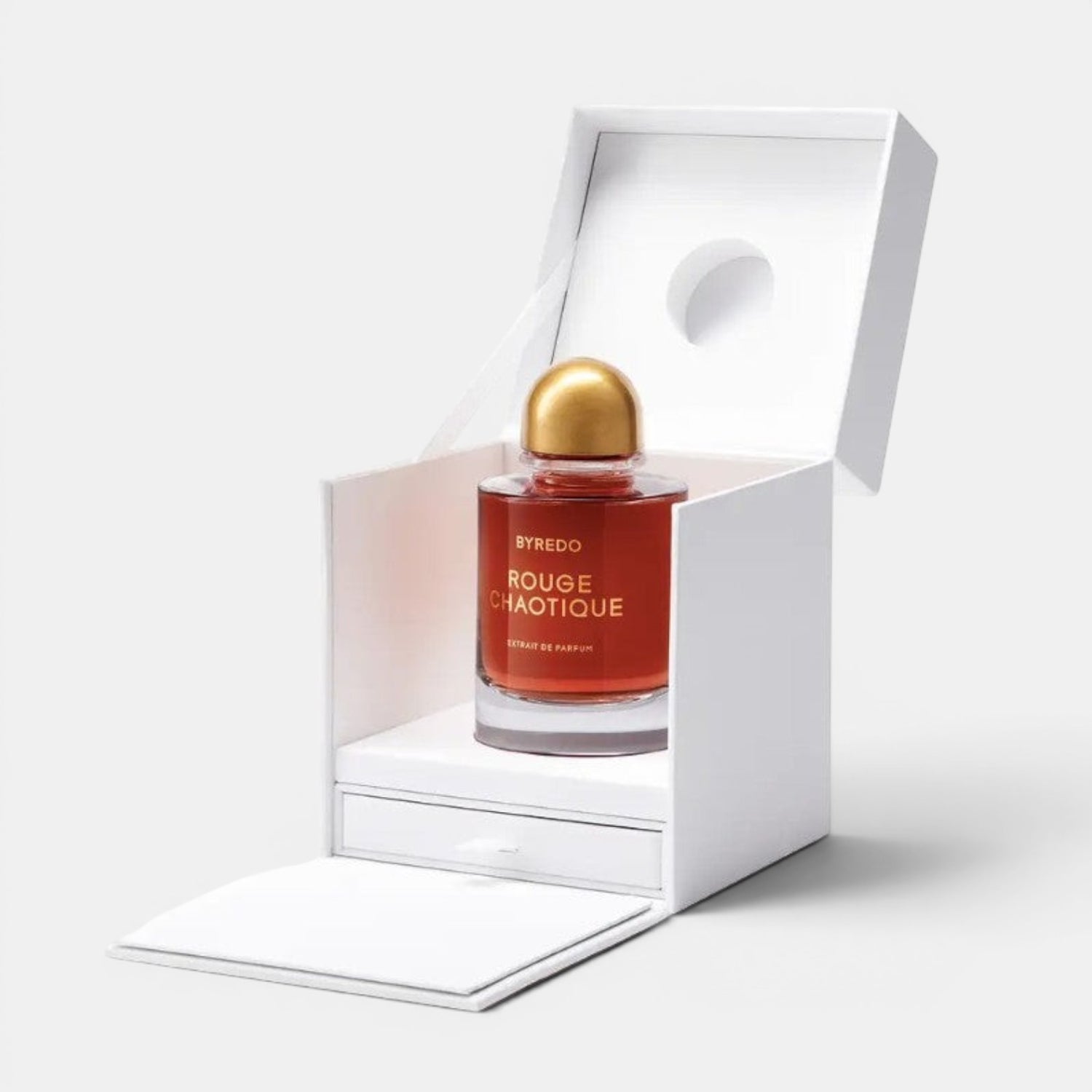 Shop Rescue Spa BYREDO Rouge Chaotique Extrait De Parfum in a red glass bottle with a gold cap, presented in a white box.