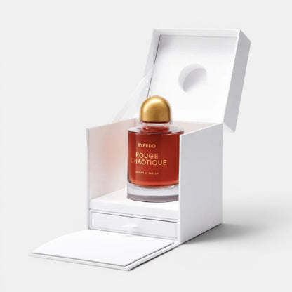 Shop Rescue Spa BYREDO Rouge Chaotique Extrait De Parfum in a red glass bottle with a gold cap, presented in a white box.