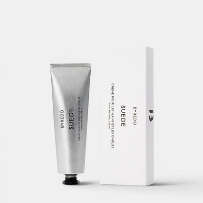 Shop Rescue Spa Byredo Suede hand and nail cream in a silver tube next to its white minimalist product box.