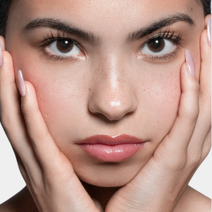 Shop Rescue Spa ÂN-GLOSS Ceramide Lip Tint on a model with glossy, shimmery pink lips and natural makeup.