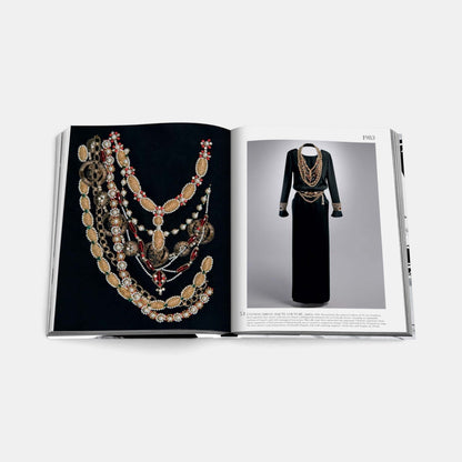 Shop Rescue Spa Chanel The Legend of an Icon book open to a page showing vintage Chanel jewelry and a black evening dress