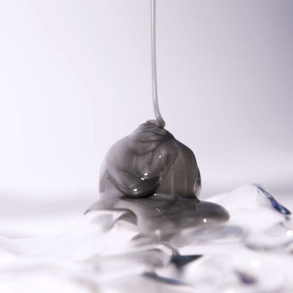 Shop Rescue Spa Extreme Caviar Purifying Charcoal Shampoo with a thick grey charcoal texture dripping