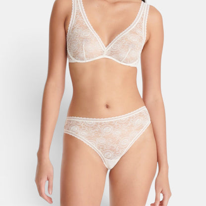 Shop Rescue Spa Citrine Lys white lace tanga bikini bottom with intricate floral patterns on a model