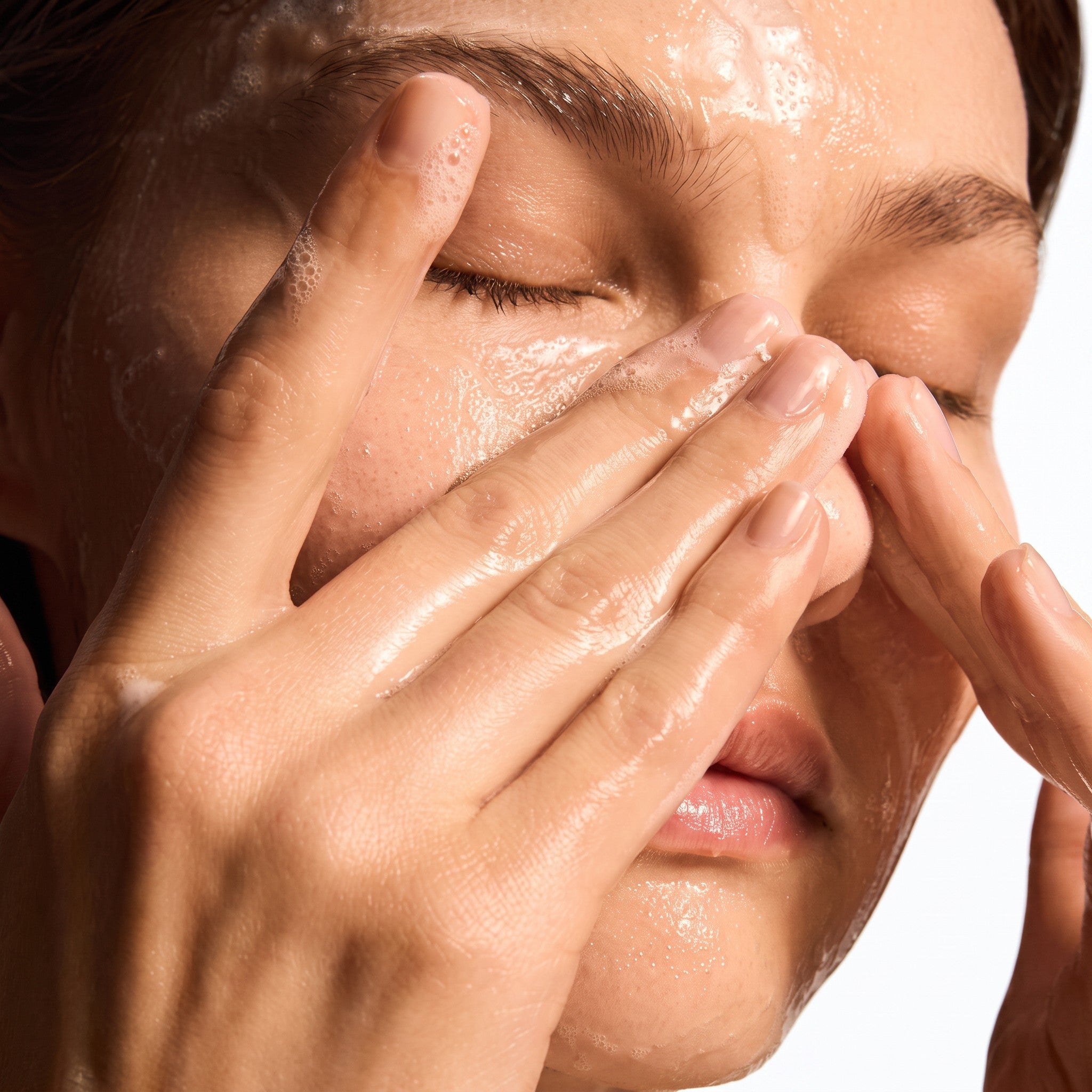 Shop Rescue Spa model gently massaging iS Clinical Cleansing Complex gel onto her face for deep pore cleansing