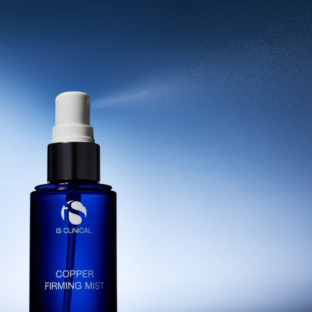 Shop Rescue Spa iS Clinical Copper Firming Mist in a blue bottle spraying a fine hydrating facial mist